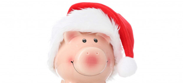 A piggy bank with a santa hat on 