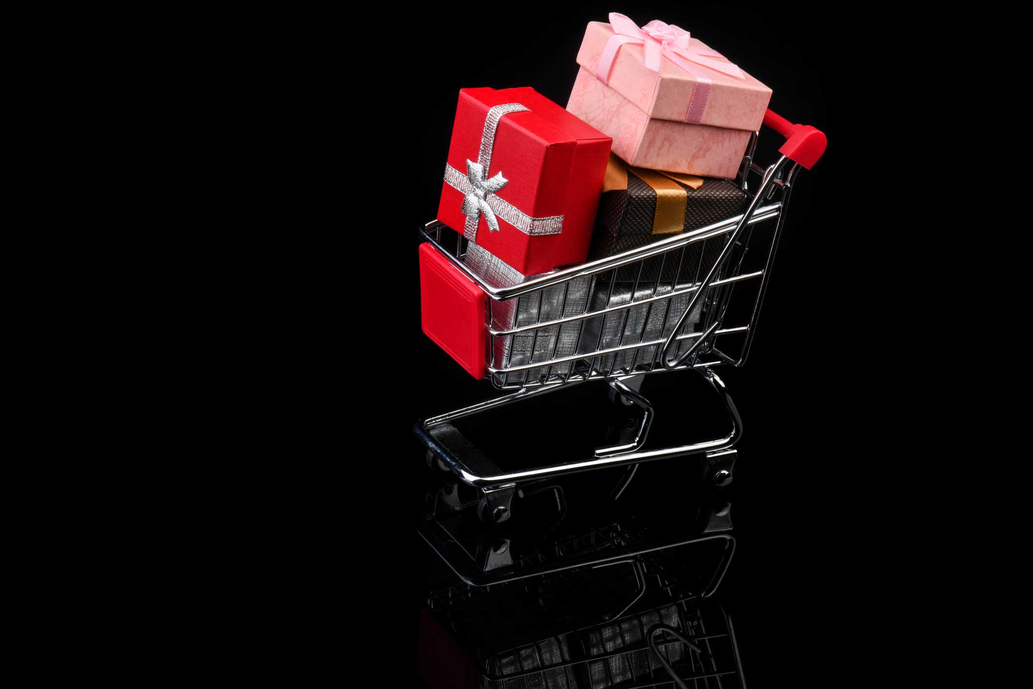 A shopping trolly with wrapped presents inside